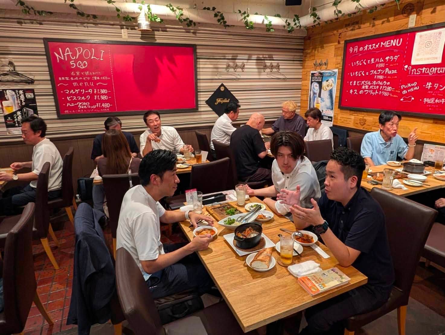 活動報告会後の交流会で食事をしながら懇談する会員